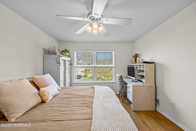 bedroom featuring baseboards, a ceiling fan, and light wood-type flooring