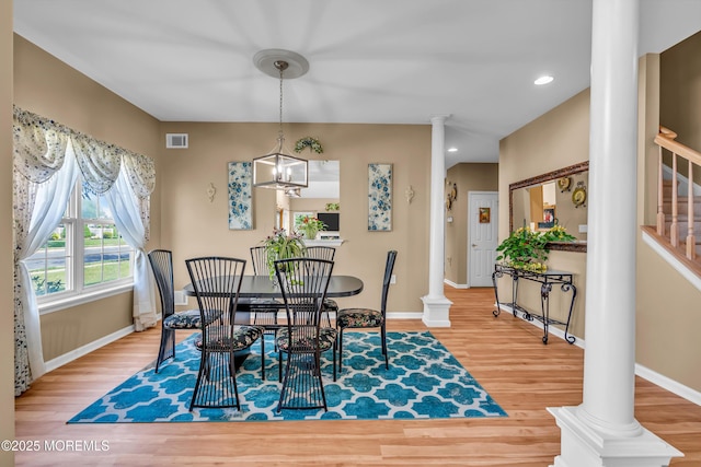 dining space featuring decorative columns, wood finished floors, baseboards, stairway, and recessed lighting