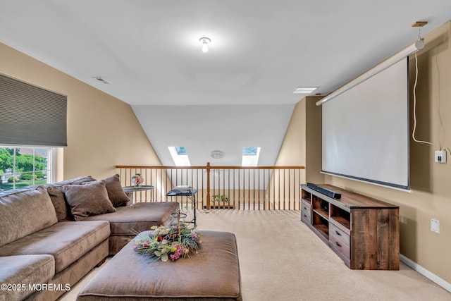 carpeted living room with a skylight and lofted ceiling