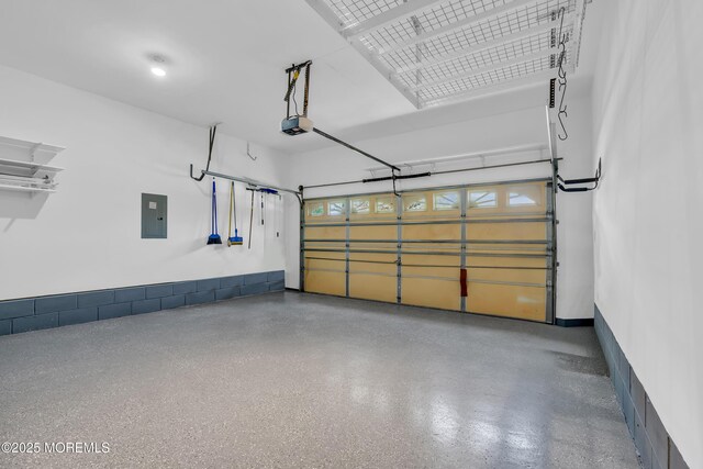 garage featuring electric panel and a garage door opener