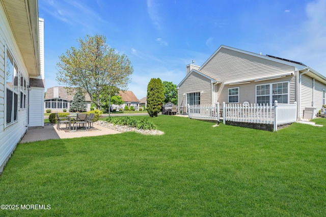 view of green lawn with a patio area