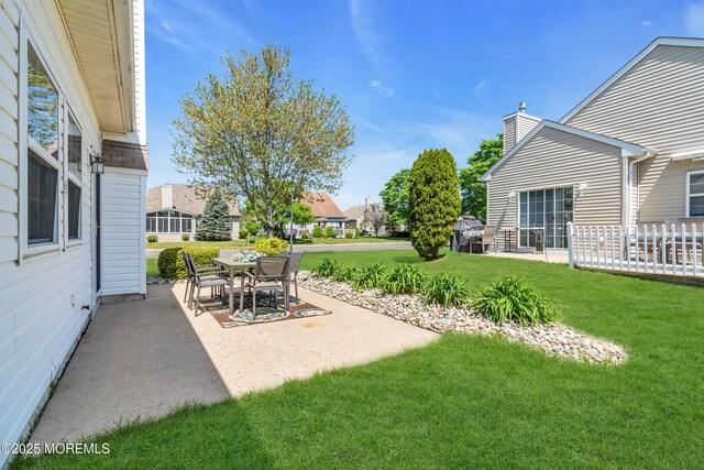 view of grassy yard featuring a patio area