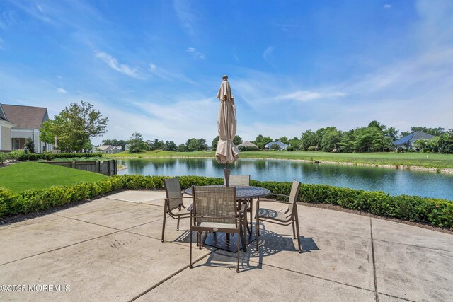 view of patio / terrace with a water view and outdoor dining area
