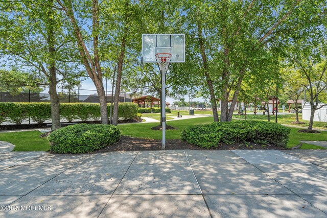 view of basketball court with a yard and basketball court
