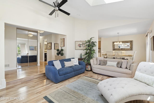 90 Oak Ln, Eatontown, NJ 07724 - living room with light wood-type flooring, a ceiling fan, a chandelier, and lofted ceiling