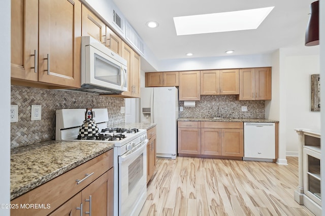 90 Oak Ln, Eatontown, NJ 07724 - kitchen featuring white appliances, a skylight, decorative backsplash, light stone countertops, and recessed lighting