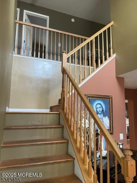 staircase with a towering ceiling