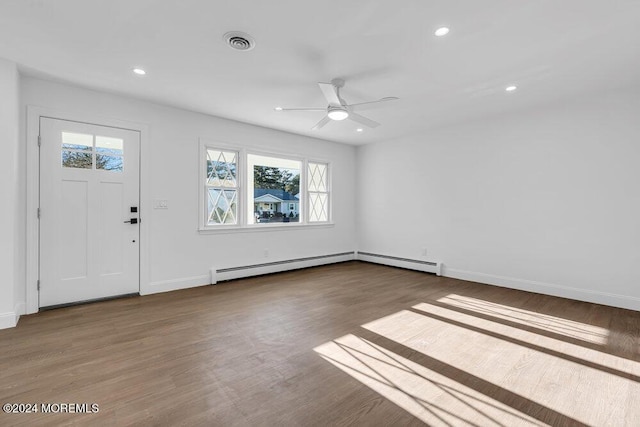 foyer entrance featuring ceiling fan, visible vents, baseboard heating, wood finished floors, and recessed lighting