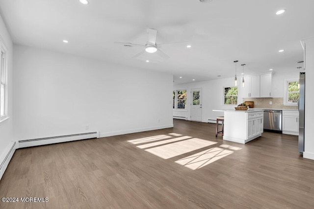 unfurnished living room with a baseboard radiator, a baseboard heating unit, recessed lighting, and dark wood-style floors