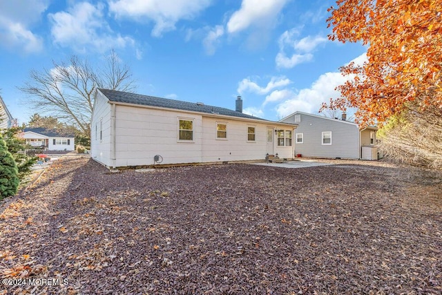rear view of property with a patio and a chimney