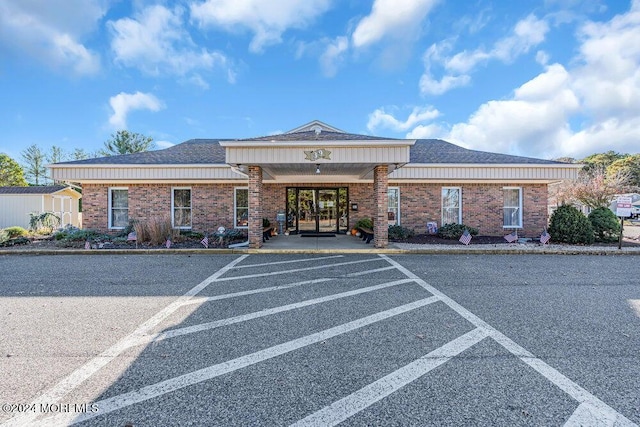 view of building exterior with uncovered parking