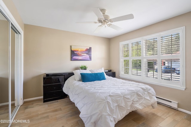 436A New Castle Ct, Manchester, NJ 08759 - bedroom featuring baseboard heating, a ceiling fan, baseboards, wood finished floors, and a closet