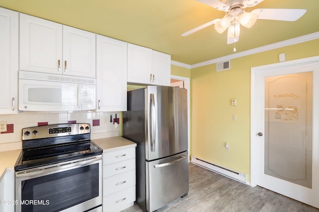 436A New Castle Ct, Manchester, NJ 08759 - kitchen with visible vents, appliances with stainless steel finishes, baseboard heating, light countertops, and ornamental molding