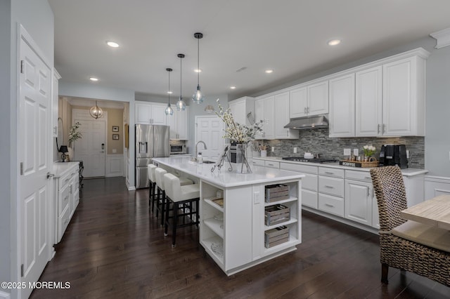 kitchen featuring open shelves, under cabinet range hood, white cabinets, and stainless steel appliances