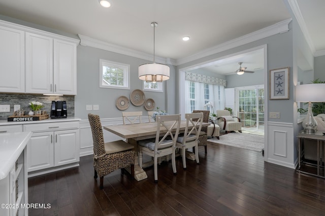 dining space with crown molding, wainscoting, and a wealth of natural light