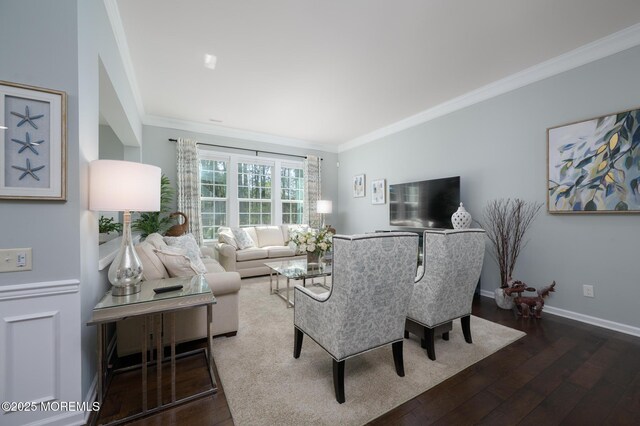 living area with crown molding, baseboards, and hardwood / wood-style floors