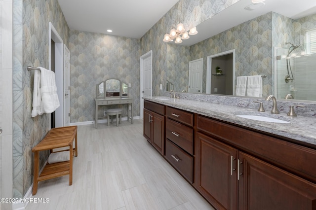 bathroom with double vanity, baseboards, and a sink
