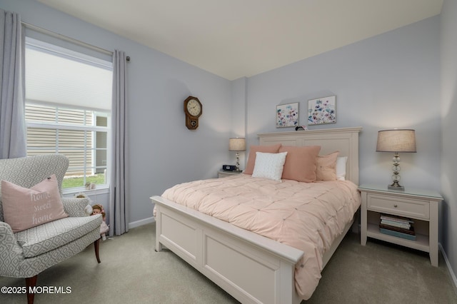 bedroom with baseboards and light colored carpet