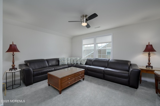living area featuring light colored carpet, ceiling fan, and visible vents