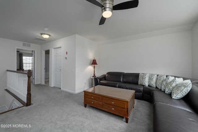 carpeted living area featuring baseboards, a ceiling fan, and visible vents