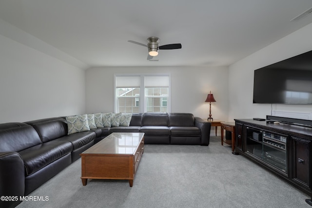living room featuring light colored carpet, ceiling fan, and visible vents