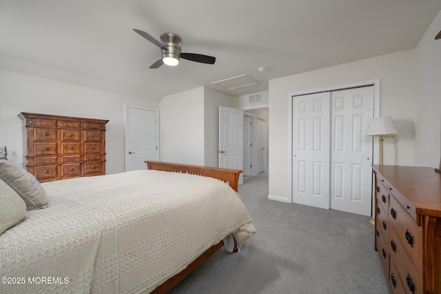 bedroom featuring ceiling fan, carpet, attic access, visible vents, and a closet