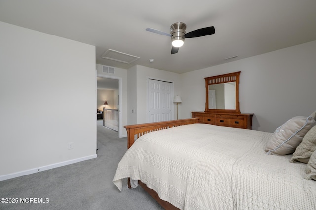 bedroom with a closet, carpet floors, attic access, and visible vents