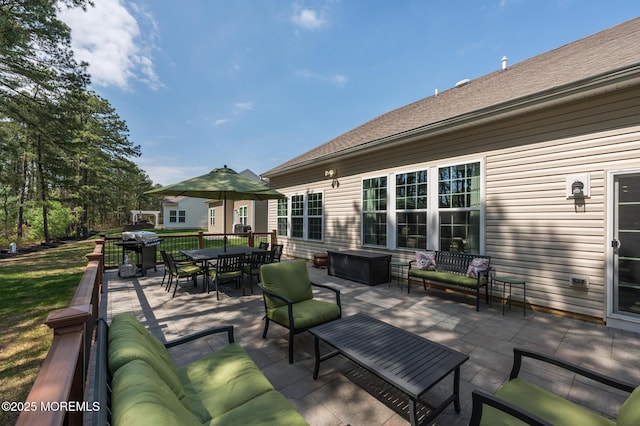view of patio / terrace with an outdoor living space, outdoor dining area, and a grill