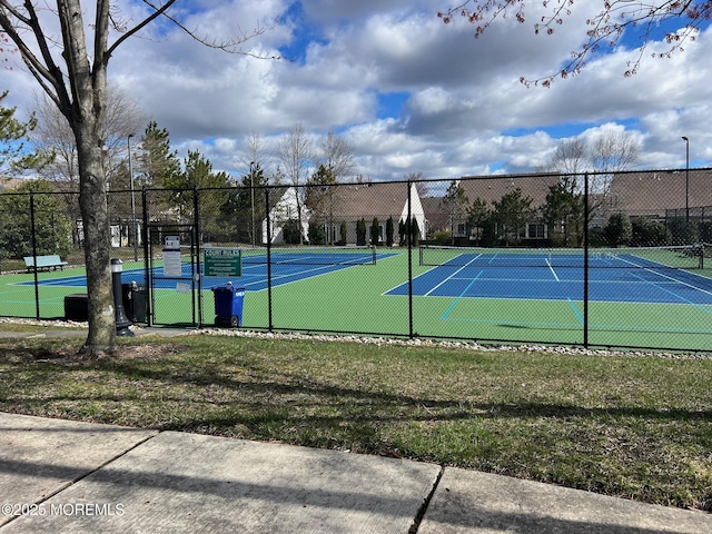 view of tennis court with fence