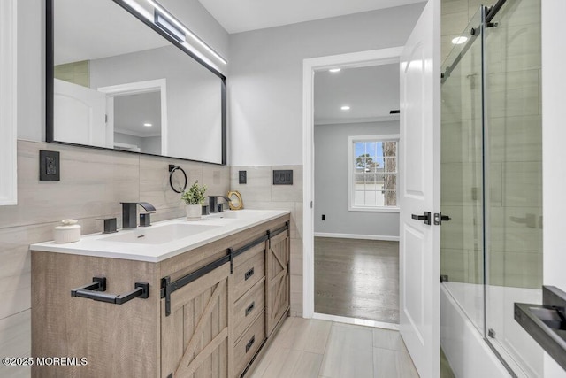 bathroom with a sink, backsplash, recessed lighting, and double vanity