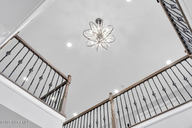 staircase featuring an inviting chandelier