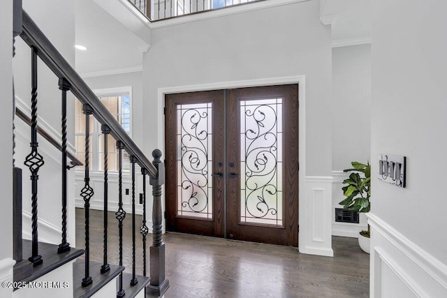 entrance foyer featuring visible vents, ornamental molding, dark wood-style flooring, and french doors