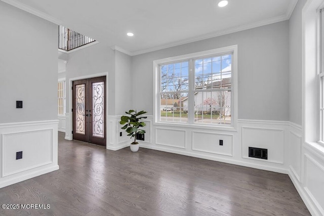 entrance foyer with visible vents, a wainscoted wall, ornamental molding, a decorative wall, and recessed lighting