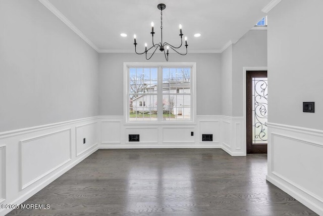 unfurnished dining area with visible vents, wainscoting, dark wood finished floors, and a chandelier