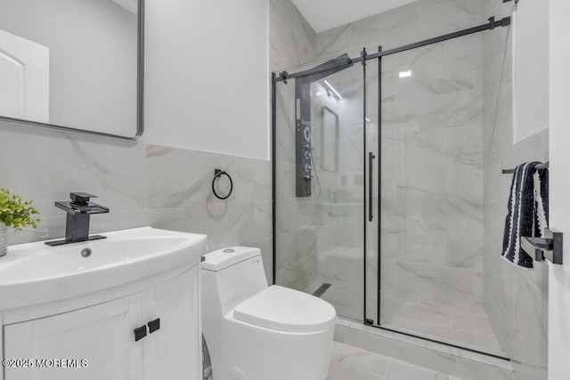 full bathroom with toilet, tile walls, a marble finish shower, and vanity