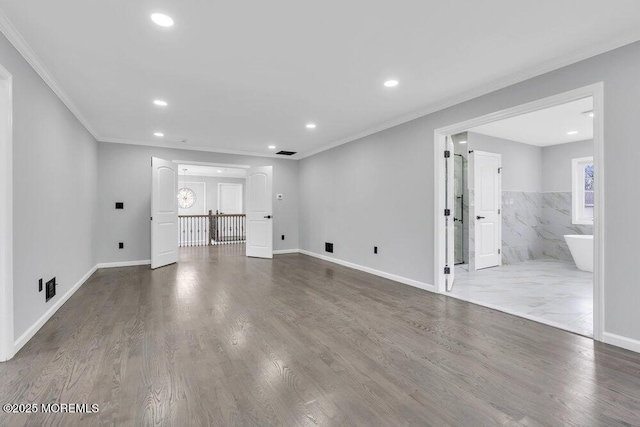 unfurnished living room featuring crown molding, recessed lighting, baseboards, and wood finished floors