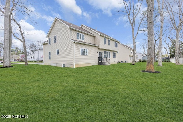 back of house with a lawn