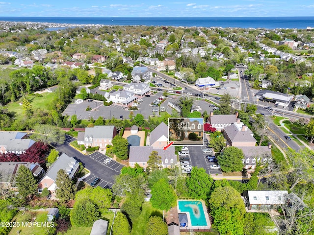 drone / aerial view with a water view and a residential view