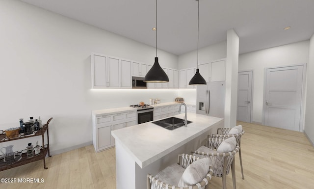 3 5th Ave Unit 206, Neptune City, NJ 07753 - kitchen with white cabinets, stainless steel appliances, a sink, and light wood-type flooring