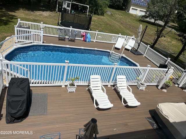 649 Toms River Rd, Jackson, NJ 08527 - outdoor pool with a trampoline, a deck, and a lawn
