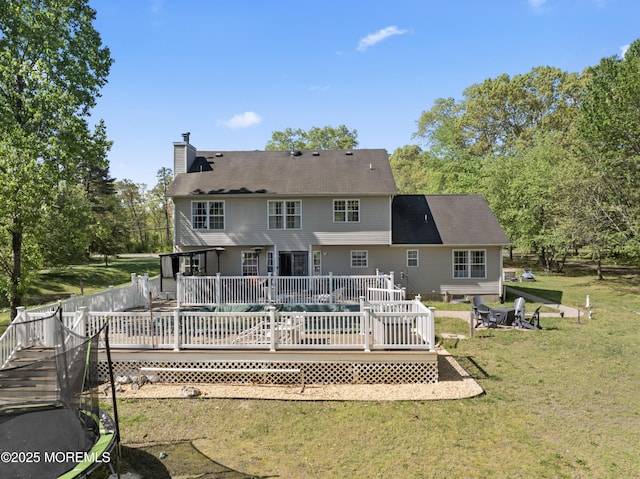 649 Toms River Rd, Jackson, NJ 08527 - rear view of house featuring a fire pit, a chimney, a lawn, and a wooden deck