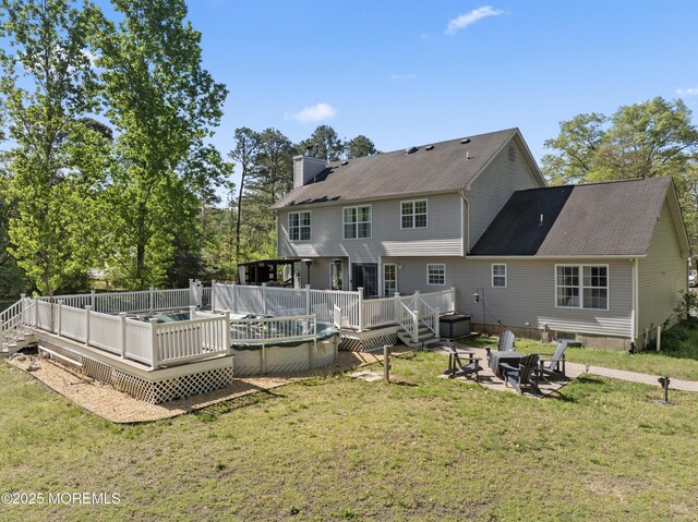649 Toms River Rd, Jackson, NJ 08527 - back of house featuring a chimney, an outdoor fire pit, a yard, a deck, and roof with shingles