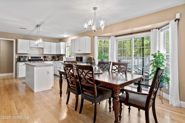 649 Toms River Rd, Jackson, NJ 08527 - dining room with a chandelier, light wood-type flooring, and baseboards