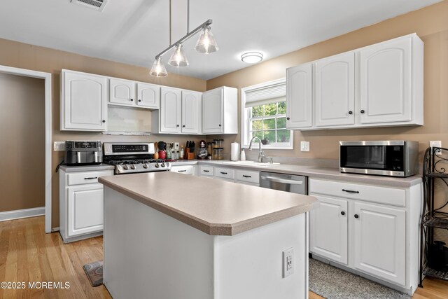 649 Toms River Rd, Jackson, NJ 08527 - kitchen with stainless steel appliances, a sink, white cabinets, and a kitchen island