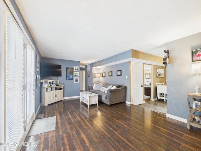 living room featuring wood finished floors and baseboards