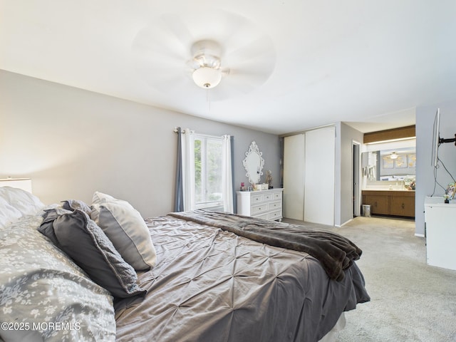 bedroom with carpet floors, a closet, and ensuite bath
