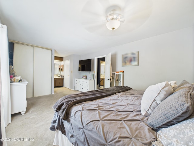 bedroom featuring light colored carpet and connected bathroom