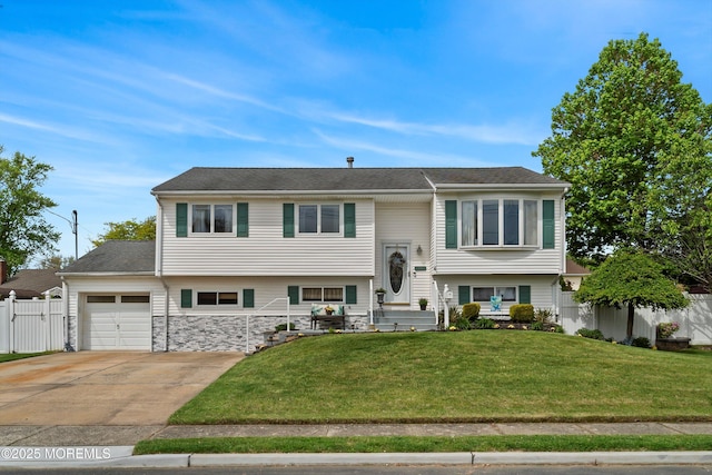 bi-level home featuring an attached garage and driveway