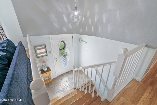 foyer entrance with wood finished floors and baseboards