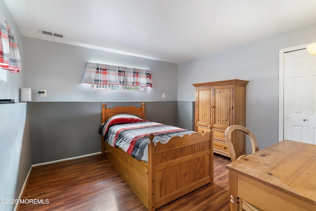 bedroom featuring wood finished floors and baseboards